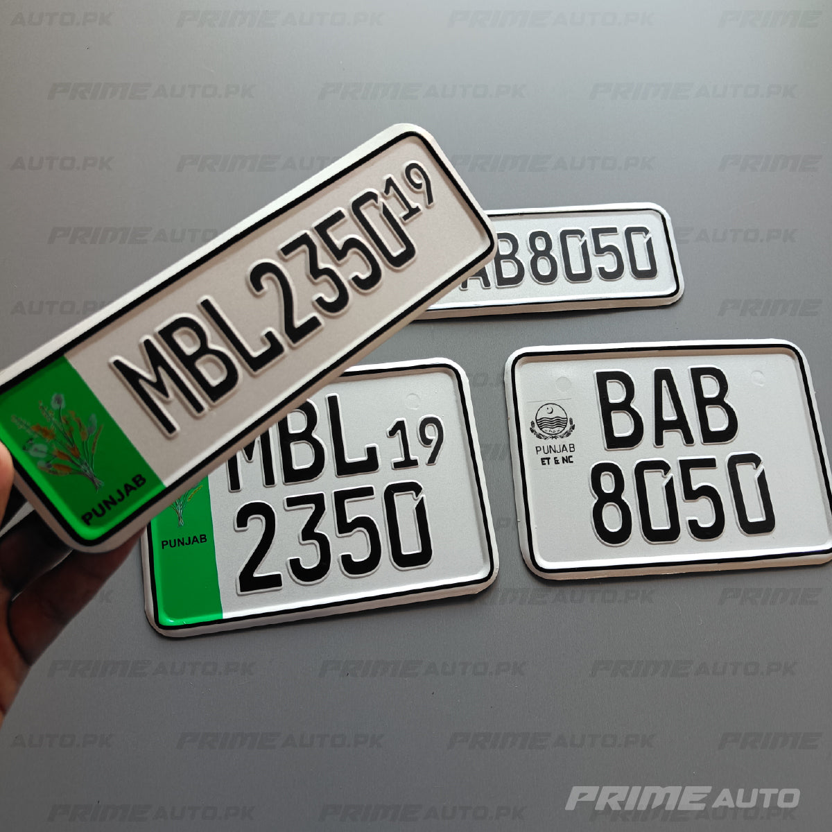 embossed punjab old bike number plate in hand